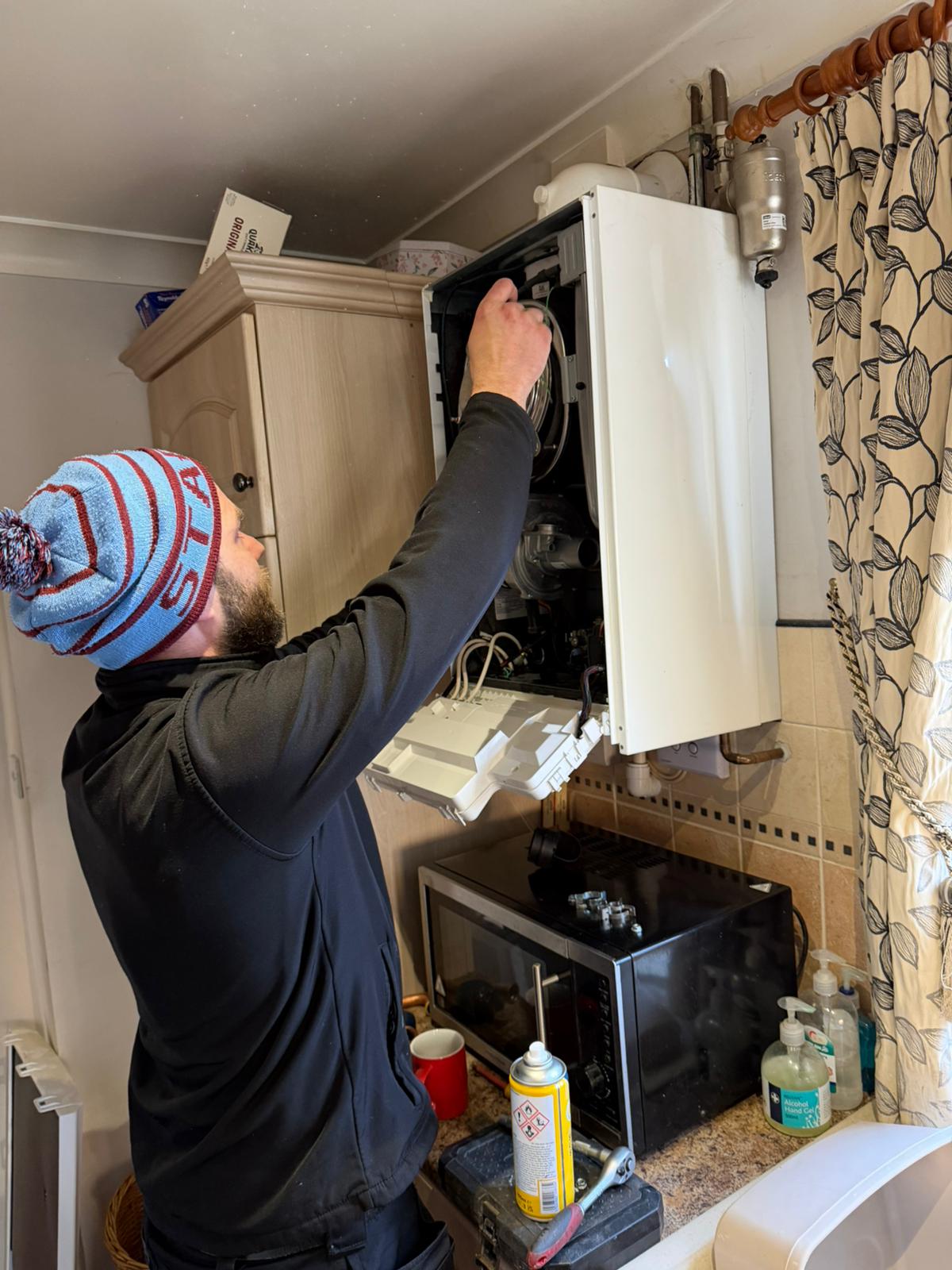 Engineer working on an open boiler during a service
